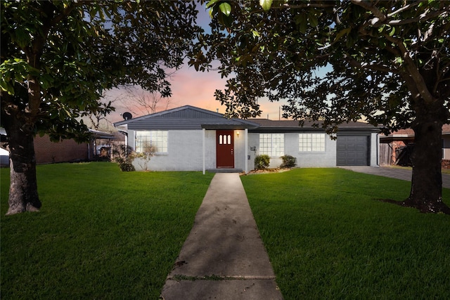 view of front of home with a garage, driveway, and a front yard