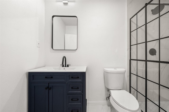 bathroom with toilet, vanity, and a tile shower