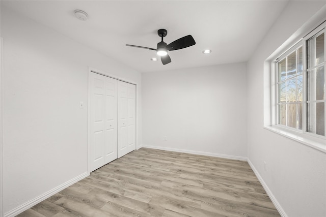 unfurnished bedroom with light wood-style flooring, recessed lighting, a closet, baseboards, and ceiling fan