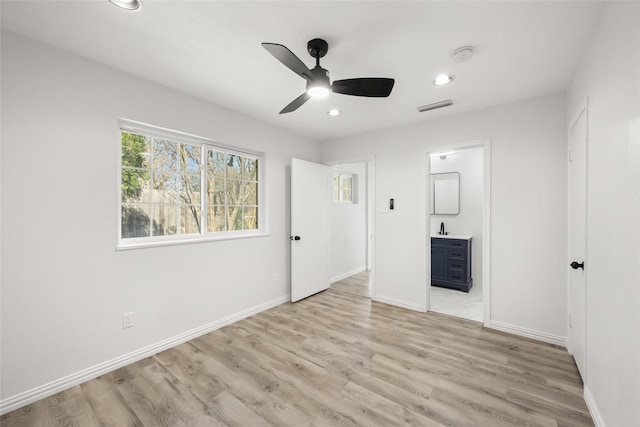 unfurnished bedroom with baseboards, visible vents, and light wood finished floors