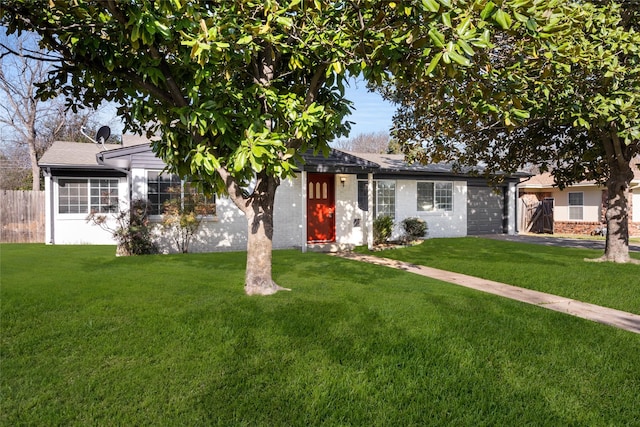 single story home with an attached garage, a front yard, and fence