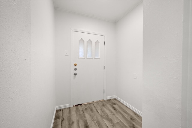 doorway to outside with baseboards and light wood finished floors