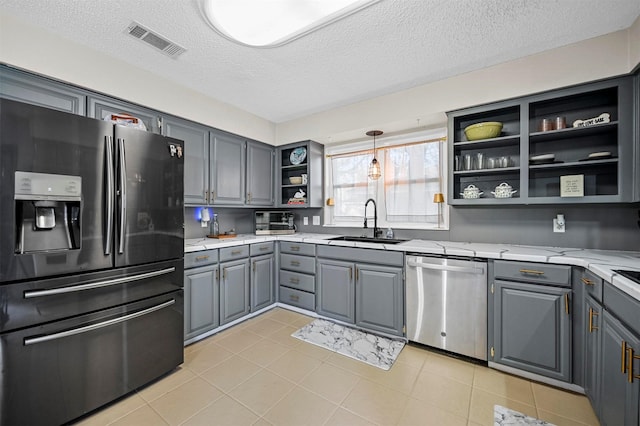 kitchen featuring visible vents, gray cabinetry, open shelves, a sink, and stainless steel appliances