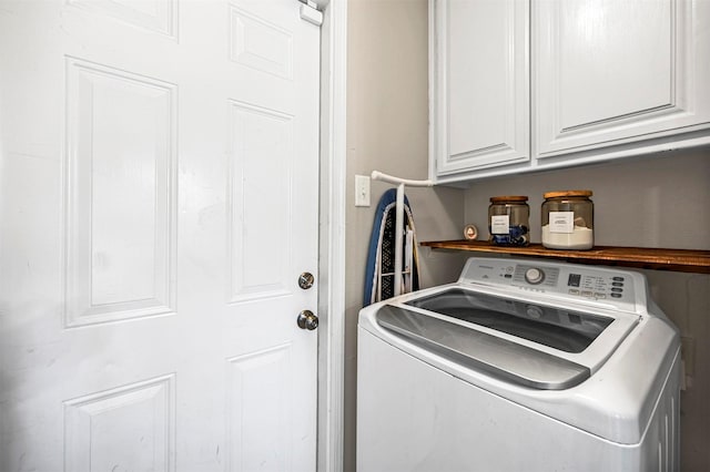 washroom featuring cabinet space and washer / dryer