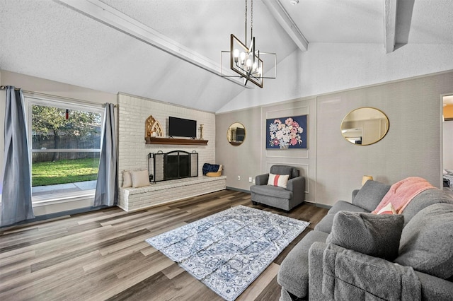 living area featuring an inviting chandelier, lofted ceiling with beams, wood finished floors, and a textured ceiling