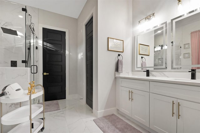 bathroom with a marble finish shower, baseboards, double vanity, marble finish floor, and a sink