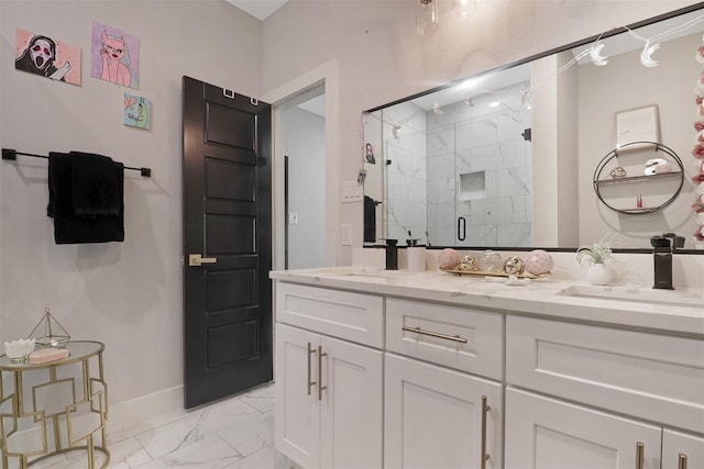 bathroom with a marble finish shower, marble finish floor, double vanity, and a sink