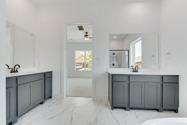 bathroom featuring visible vents, ceiling fan, a sink, a shower stall, and marble finish floor