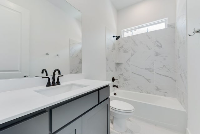 full bath featuring marble finish floor, toilet, vanity, and  shower combination