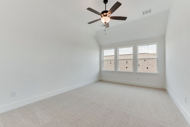 unfurnished room with baseboards, visible vents, lofted ceiling, ceiling fan, and light carpet