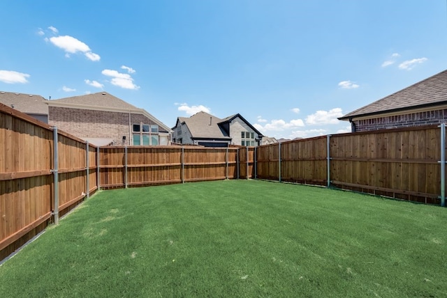 view of yard with a fenced backyard