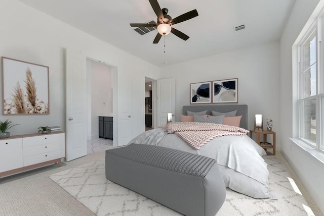 bedroom with visible vents, light carpet, and ceiling fan