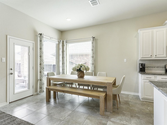 dining room featuring visible vents and baseboards