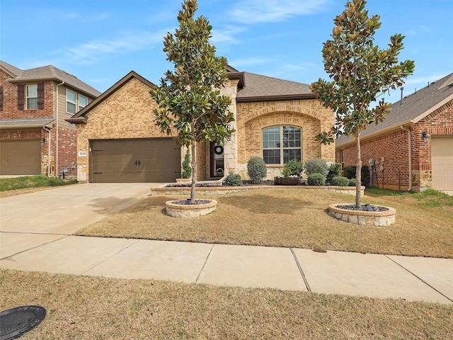 view of front facade with driveway, an attached garage, a shingled roof, a front lawn, and brick siding