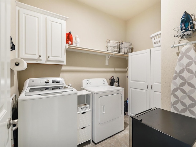 laundry room with washer and dryer and cabinet space