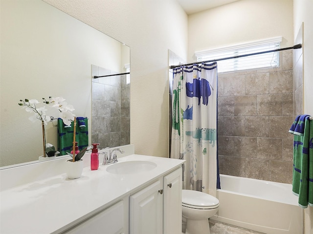 bathroom featuring vanity, shower / tub combo, and toilet