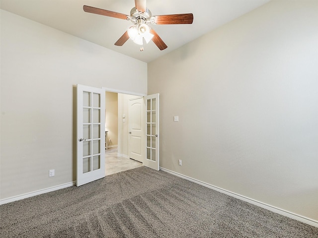 carpeted spare room with french doors, baseboards, and ceiling fan