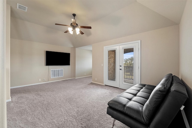 unfurnished living room with visible vents, lofted ceiling, ceiling fan, and carpet flooring