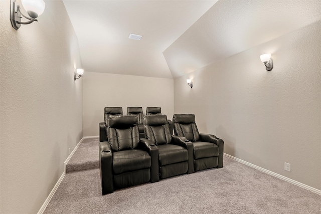 cinema room featuring lofted ceiling, baseboards, and carpet floors