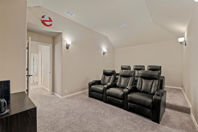 cinema room featuring lofted ceiling, carpet flooring, baseboards, and visible vents