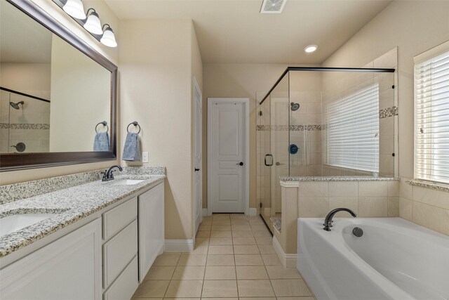 full bath featuring tile patterned floors, visible vents, a garden tub, a sink, and a shower stall