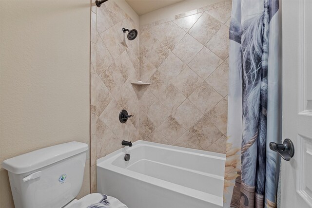 bathroom with toilet, shower / bath combo with shower curtain, and a textured wall