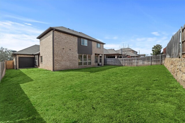 view of yard with a fenced backyard and an attached garage