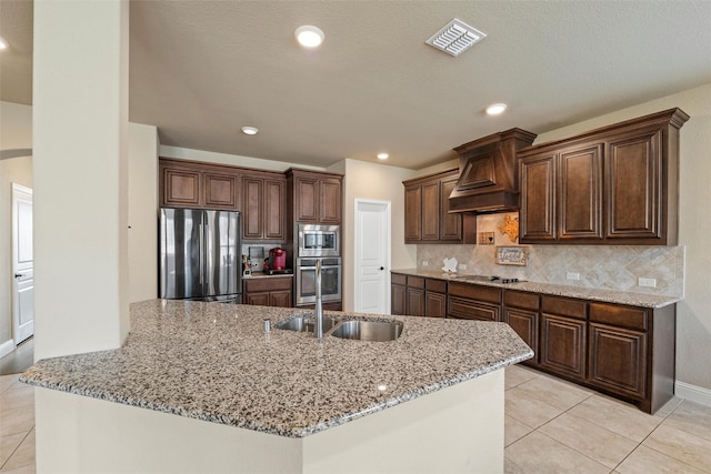 kitchen with light tile patterned floors, light stone countertops, visible vents, decorative backsplash, and appliances with stainless steel finishes