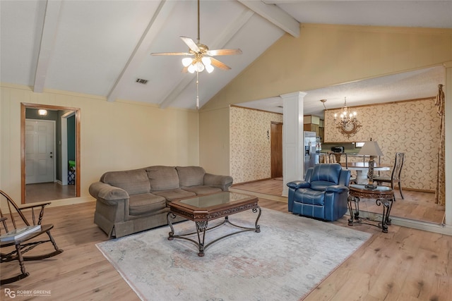 living room with wallpapered walls, wood finished floors, decorative columns, and ceiling fan with notable chandelier