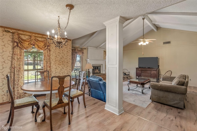 dining room featuring visible vents, a textured ceiling, vaulted ceiling with beams, and ceiling fan with notable chandelier