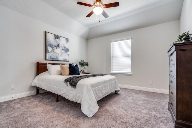 carpeted bedroom featuring a ceiling fan, baseboards, and vaulted ceiling