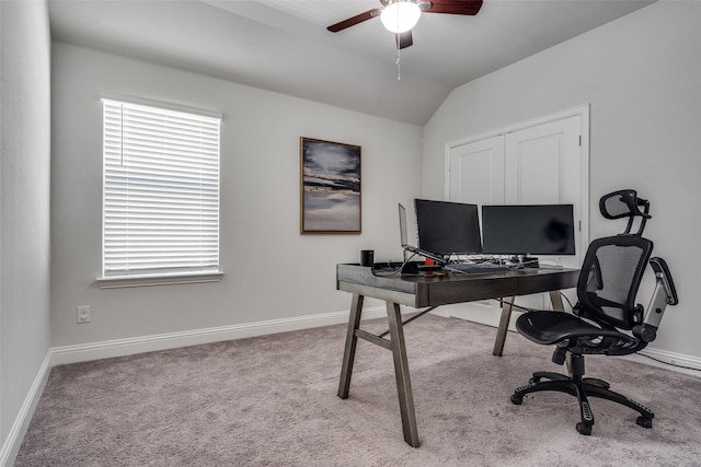 office space with vaulted ceiling, carpet flooring, baseboards, and ceiling fan