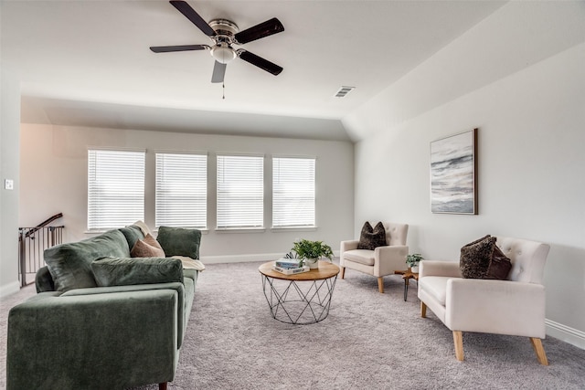 carpeted living area with visible vents, ceiling fan, and baseboards