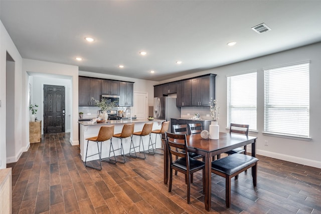 dining space with visible vents, recessed lighting, dark wood-style flooring, and baseboards