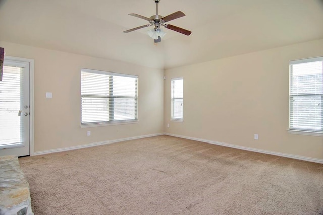 unfurnished room with light colored carpet, baseboards, and ceiling fan