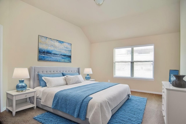 bedroom featuring vaulted ceiling, light colored carpet, and baseboards