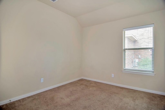 spare room with baseboards, lofted ceiling, and carpet flooring