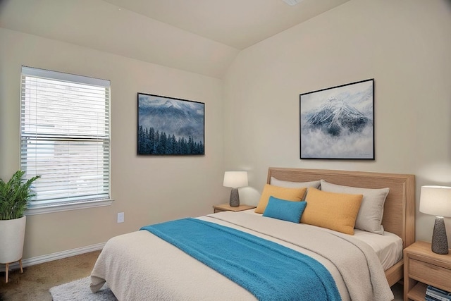 bedroom featuring baseboards, carpet flooring, and vaulted ceiling