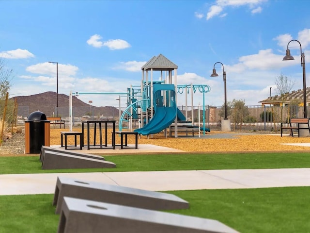 community playground with a yard and fence