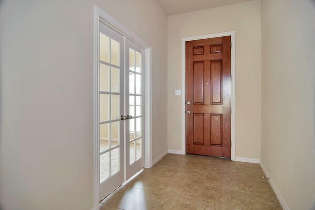 doorway to outside with light tile patterned floors and baseboards