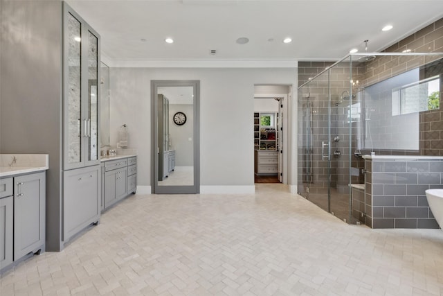 bathroom with a shower stall, crown molding, a walk in closet, recessed lighting, and vanity