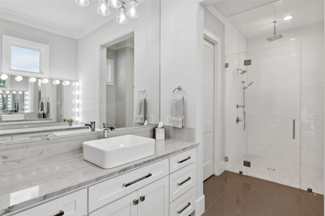 full bath with vanity, ornamental molding, a shower stall, and tile patterned flooring