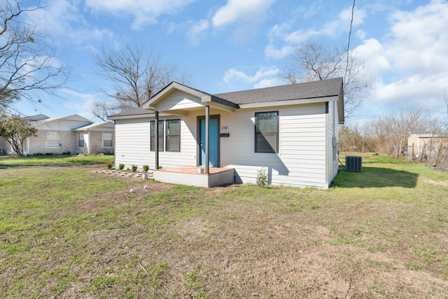 view of front of home featuring a front yard and central AC