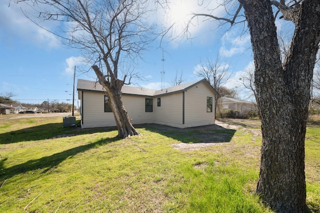 rear view of house with a yard