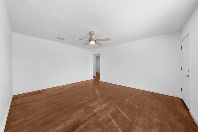 empty room with visible vents, baseboards, a ceiling fan, and wood finished floors