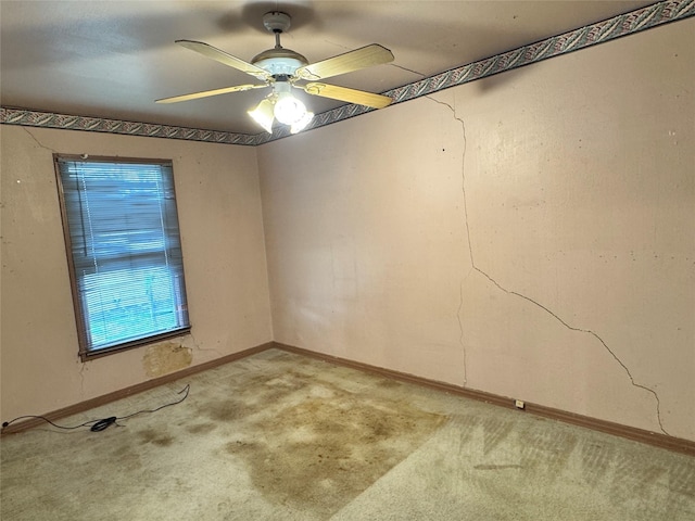 empty room with baseboards, light colored carpet, and a ceiling fan