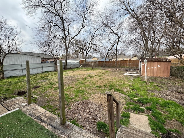 view of yard featuring an outbuilding, a fenced backyard, and a shed