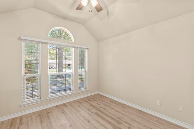 empty room with light wood finished floors, baseboards, lofted ceiling, and ceiling fan