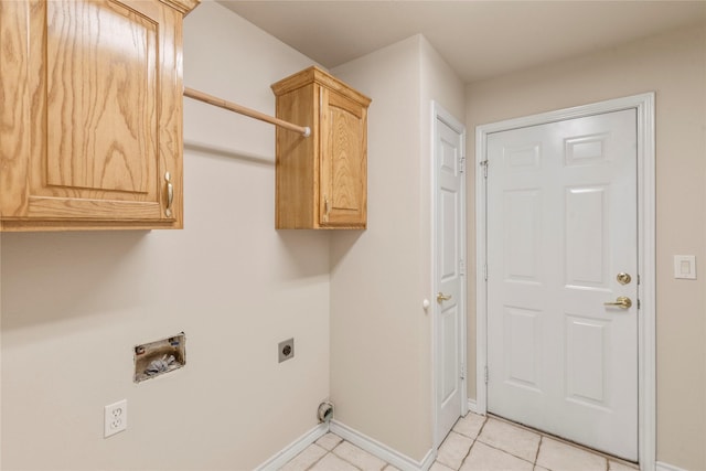 washroom featuring light tile patterned floors, cabinet space, hookup for an electric dryer, and baseboards