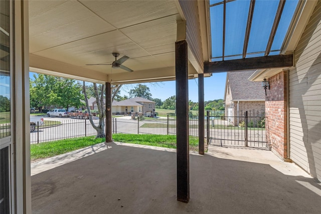 view of patio / terrace featuring a residential view, ceiling fan, and fence